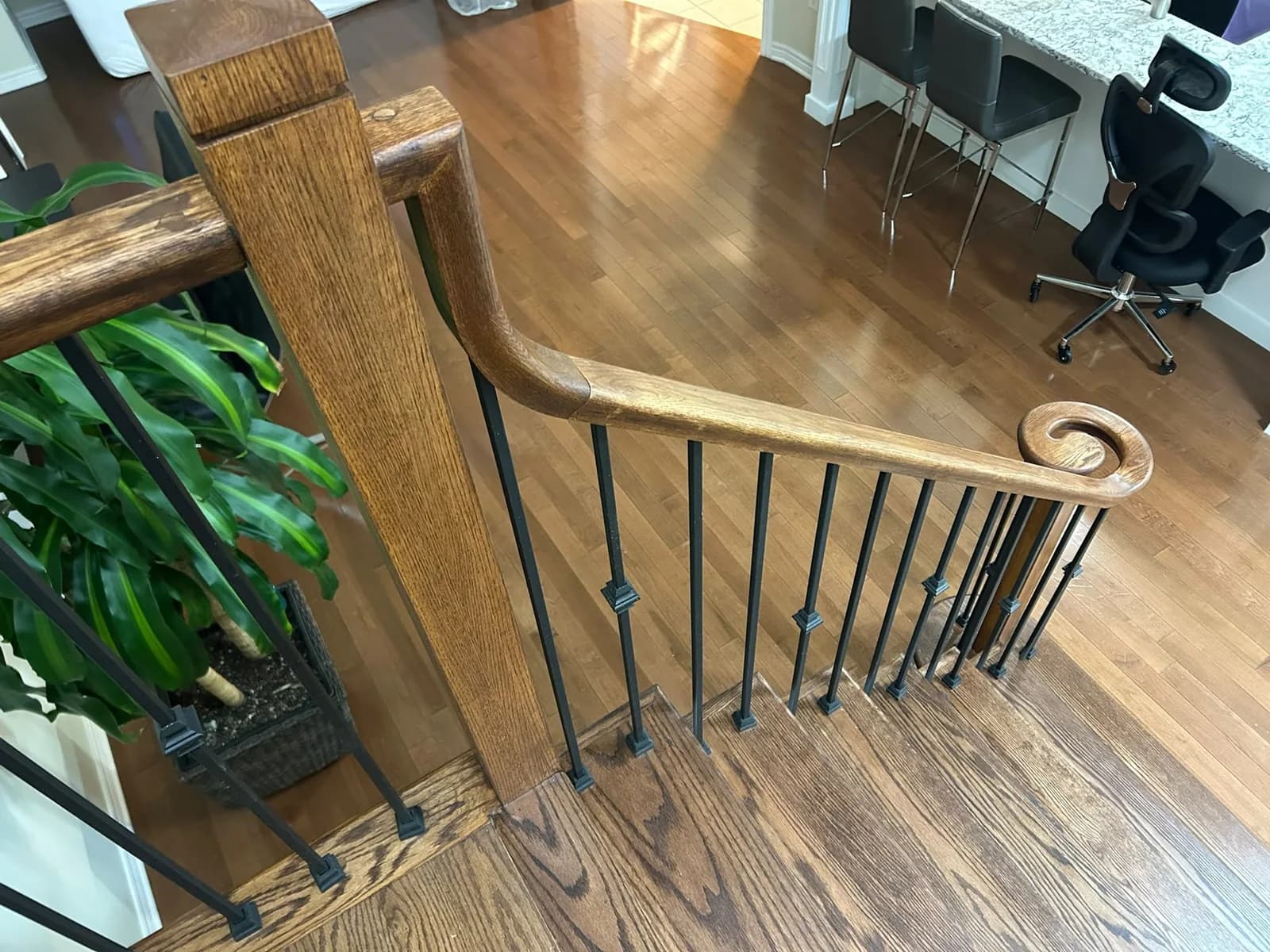 Solid oak handrail finished with a hand-worked volute