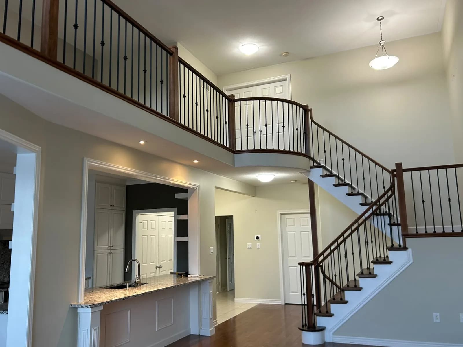 Curved Two-Storey Foyer Staircase
